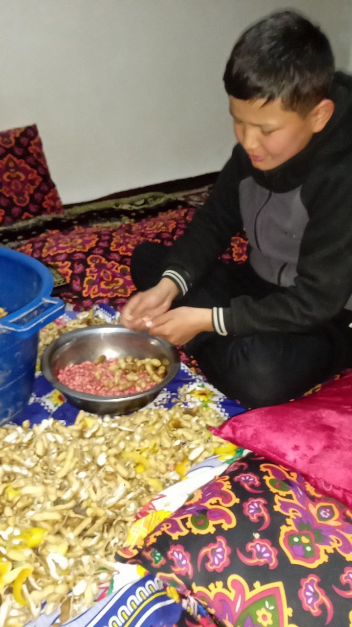 a person sitting on the floor with a bowl of food
